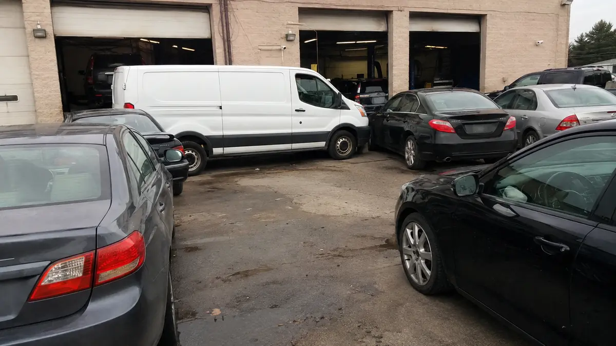 Parts delivery van outside an independent repair shop in Arlington, TX