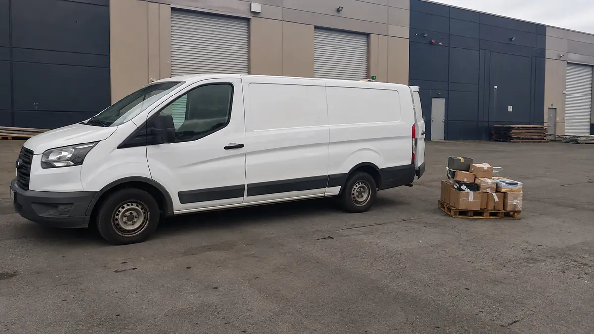 Parts delivery van outside an independent repair shop in Grand Prairie, TX
