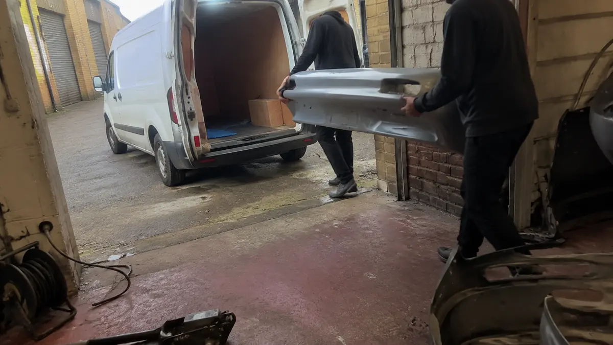 Parts delivery van outside an independent repair shop in Irving, TX